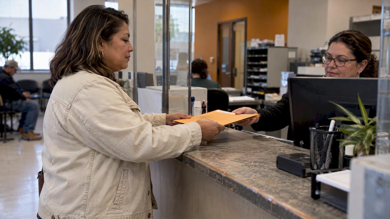 Contractor submitting lien paperwork at county counter